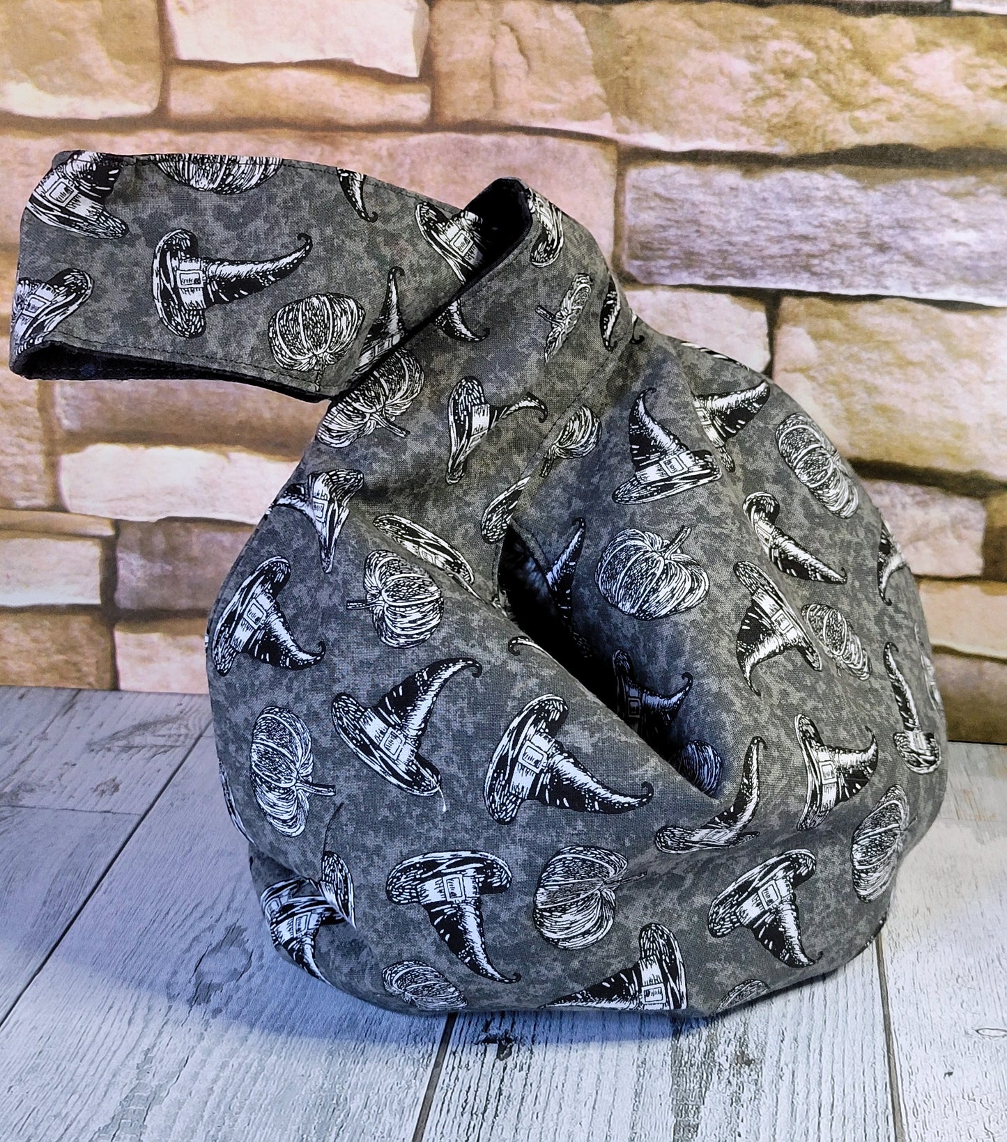 Dark gray handbag with witch hat and pumpkin pattern