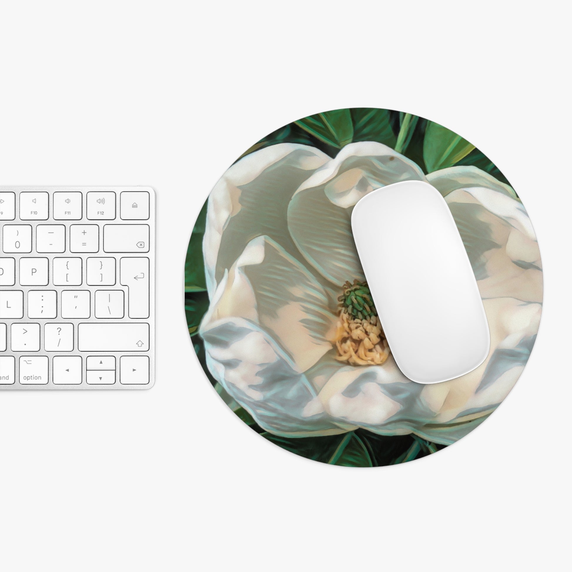Round mouse pad with floral design on a white surface next to a keyboard.