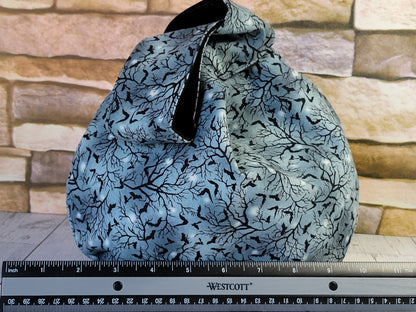 Knot bag with black tree and bats pattern with a ruler 